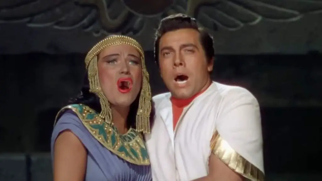 American operatic soprano Dorothy Kirsten, the American tenor and Hollywood star of Italian origin Mario Lanza, and the American operatic mezzo-soprano Blanche Thebom sing O Terra Addio, the final duet from opera Aida (Verdi), which premiered in Cairo in 1871. This scene is from The Great Caruso, a 1951 biographical film produced by Metro-Goldwyn-Mayer and starring Mario Lanza as famous operatic tenor Enrico Caruso.
