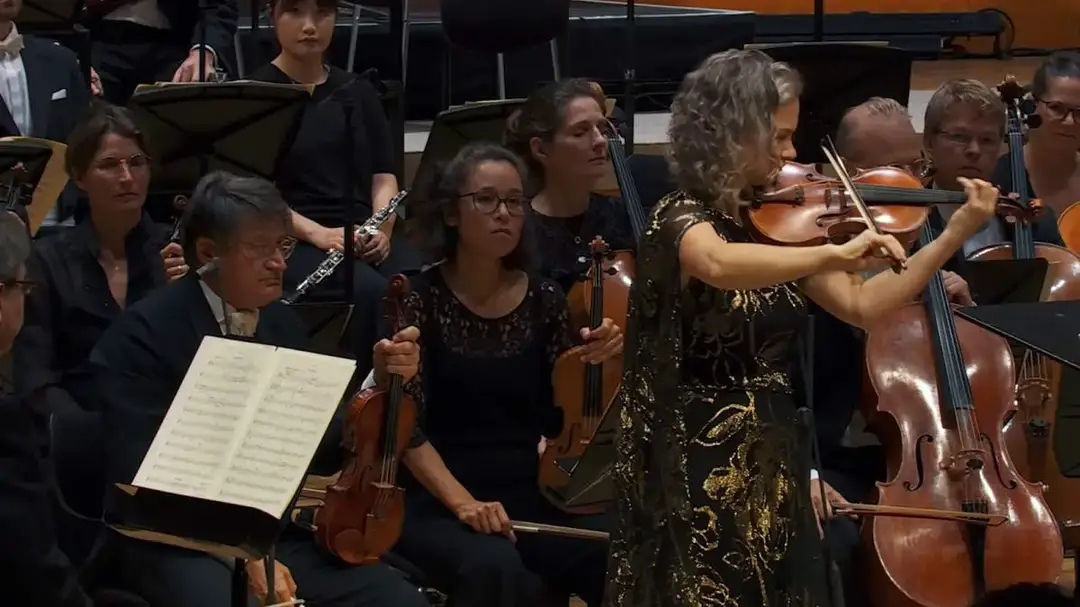 A cadenza is a virtuosic passage in a concerto where the soloist performs an elaborate, often improvised section, highlighting their technical skill and artistic mastery. Photo: Hilary Hahn performing the iconic cadenza from Tchaikovsky's Violin Concerto.